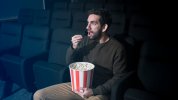 man-with-popcorn-cinema_23-2147988965.jpg